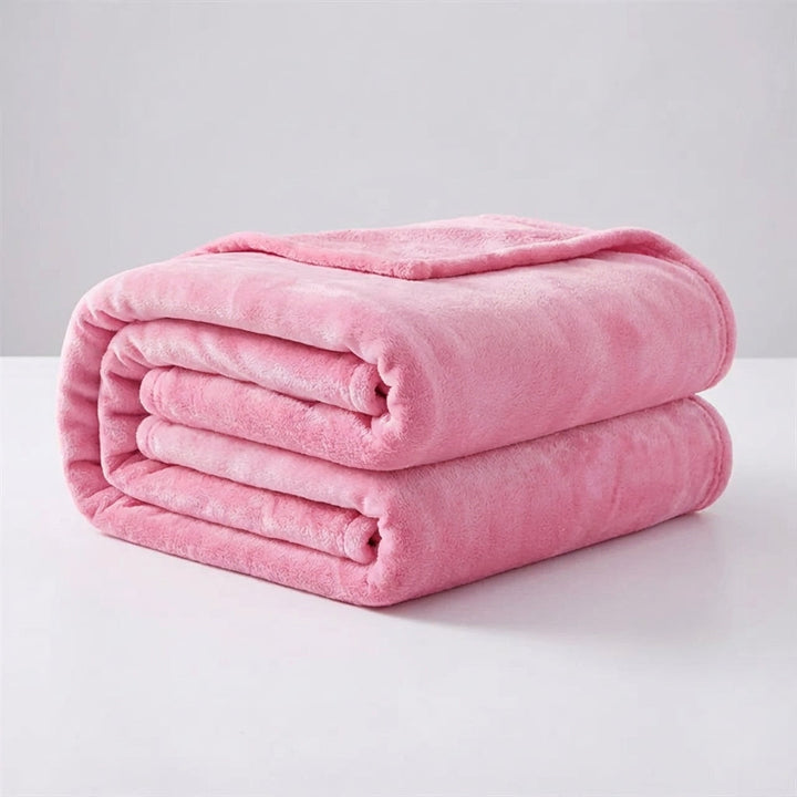 Snugluma travel blanket draped elegantly over a modern sofa