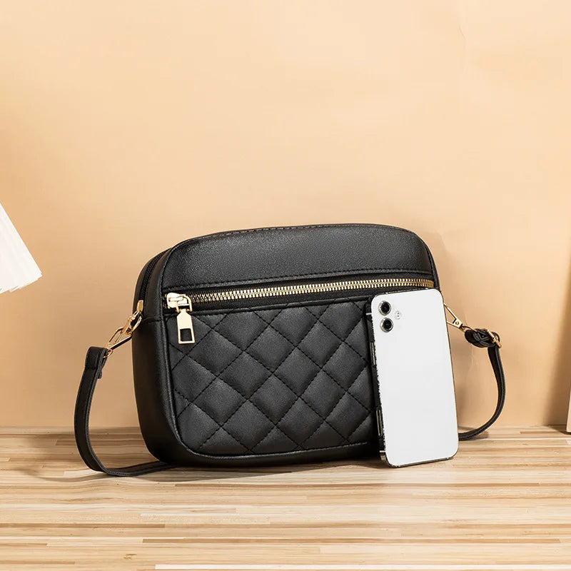 Black quilted crossbody bag worn by a model