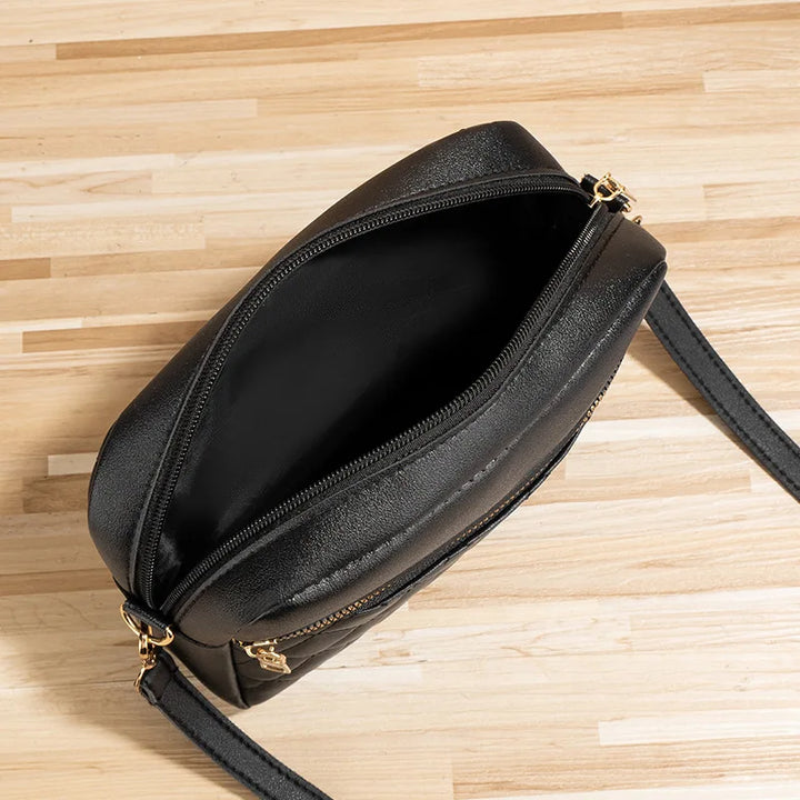 Interior view of women's quilted handbag with zipper pocket