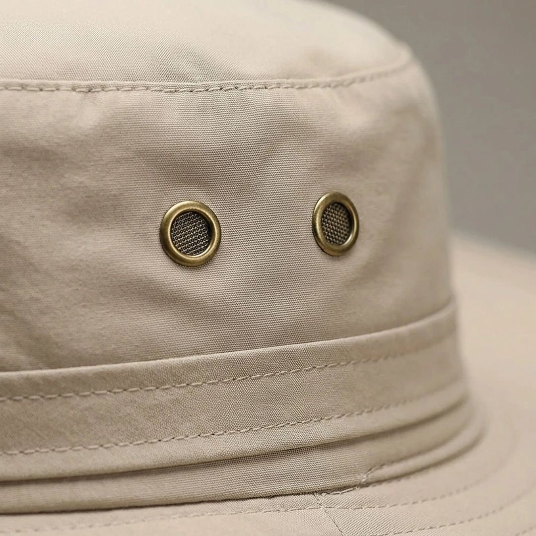 Khaki unisex summer hat worn outdoors on a bright sunny day