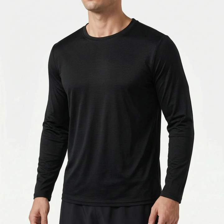 Studio shot of a man wearing a black long sleeve athletic shirt against a white background