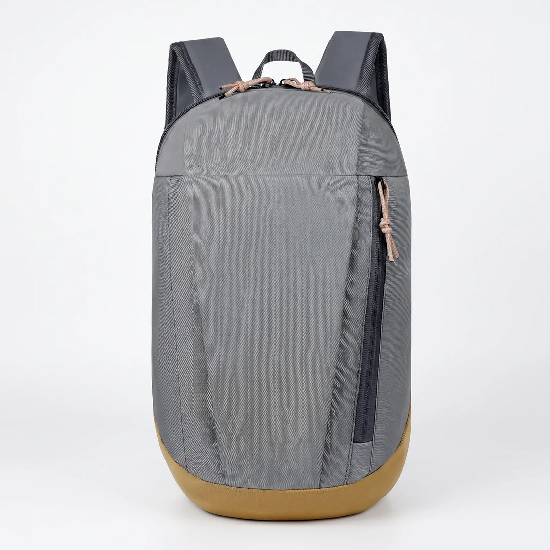 Front view of grey mini hiking rucksack with tan bottom panel on white background