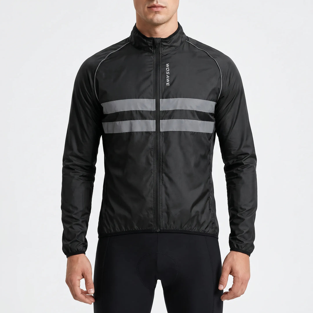Studio shot of a man wearing a black cycling windbreaker jacket with reflective stripes