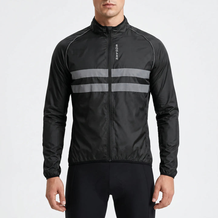 Studio shot of a man wearing a black cycling windbreaker jacket with reflective stripes
