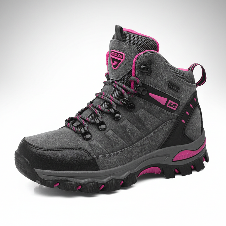 Side view of grey and pink outdoor hiking boot on white background