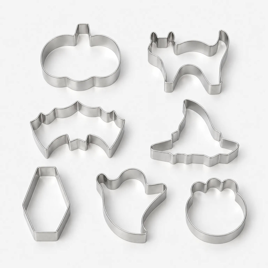 Studio shot of seven distinct Halloween shape metal cookie cutters against a clean background
