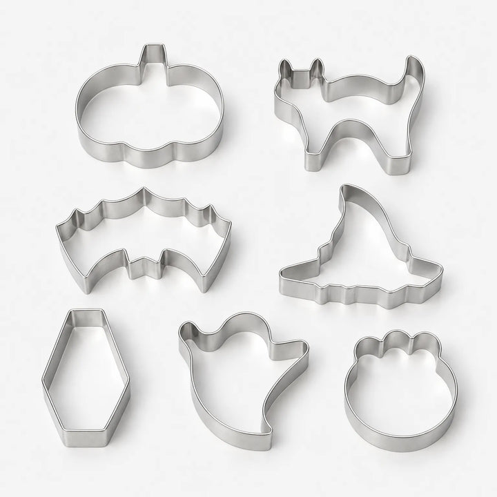 Studio shot of seven distinct Halloween shape metal cookie cutters against a clean background