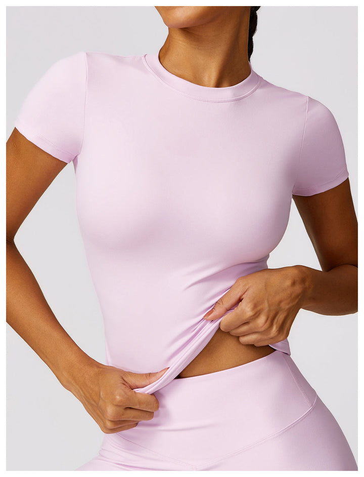 Close-up view of the pale pink short sleeve activewear top