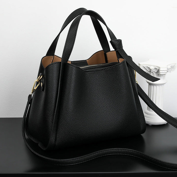 Chic green women's handbag featuring a structured design and durable strap
