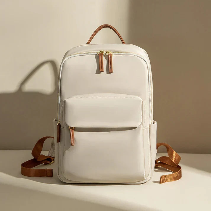 Beige adventure backpack shown front-facing on a neutral studio background
