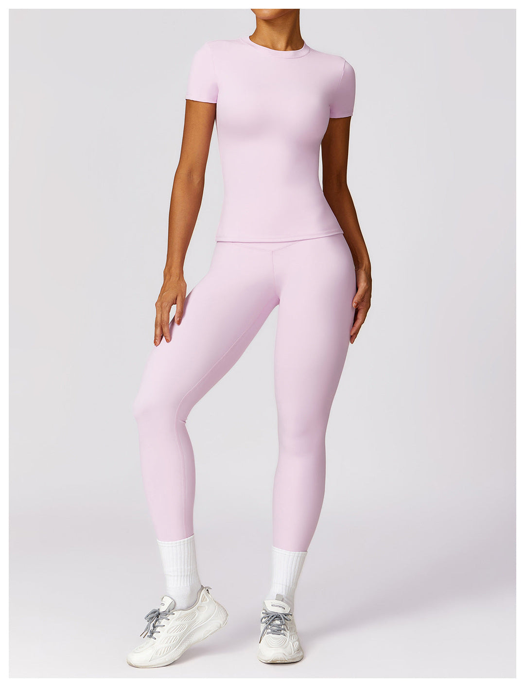 Woman wearing pale pink 2-piece shaping gym set with short sleeves
