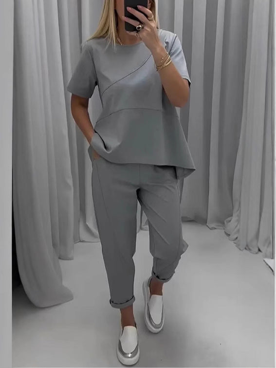 Woman wearing a gray casual two-piece set with short sleeves and trousers