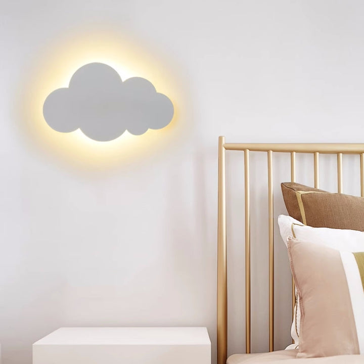 LED wall sconce in a cloud silhouette illuminating a cozy living room space