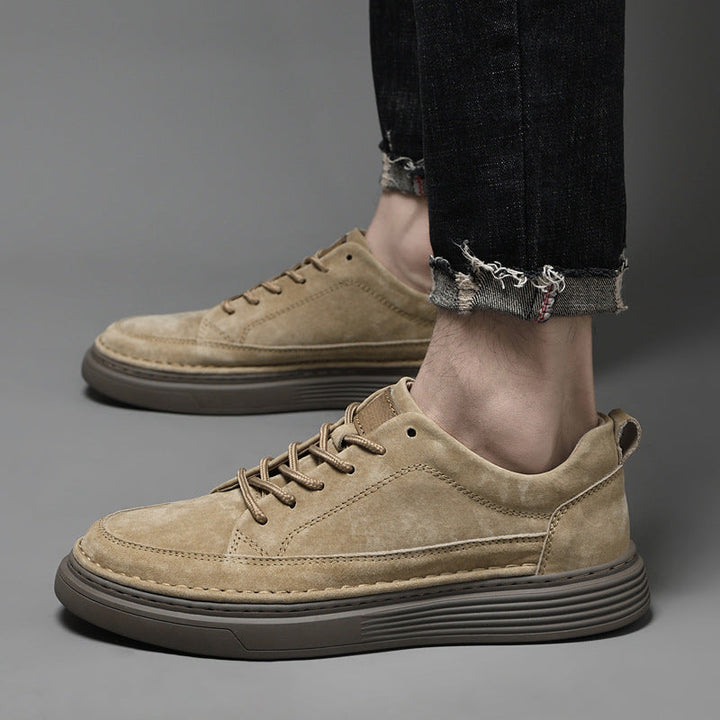 Close-up of men's casual leather sneakers worn with jeans