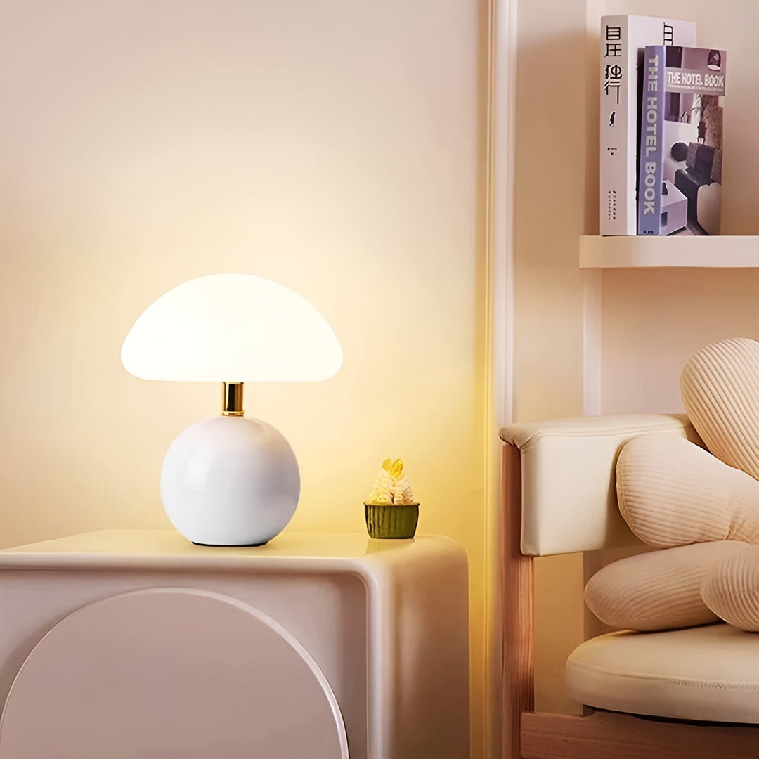 Elegant mushroom LED table lamp casting warm ambient lighting on a modern desk