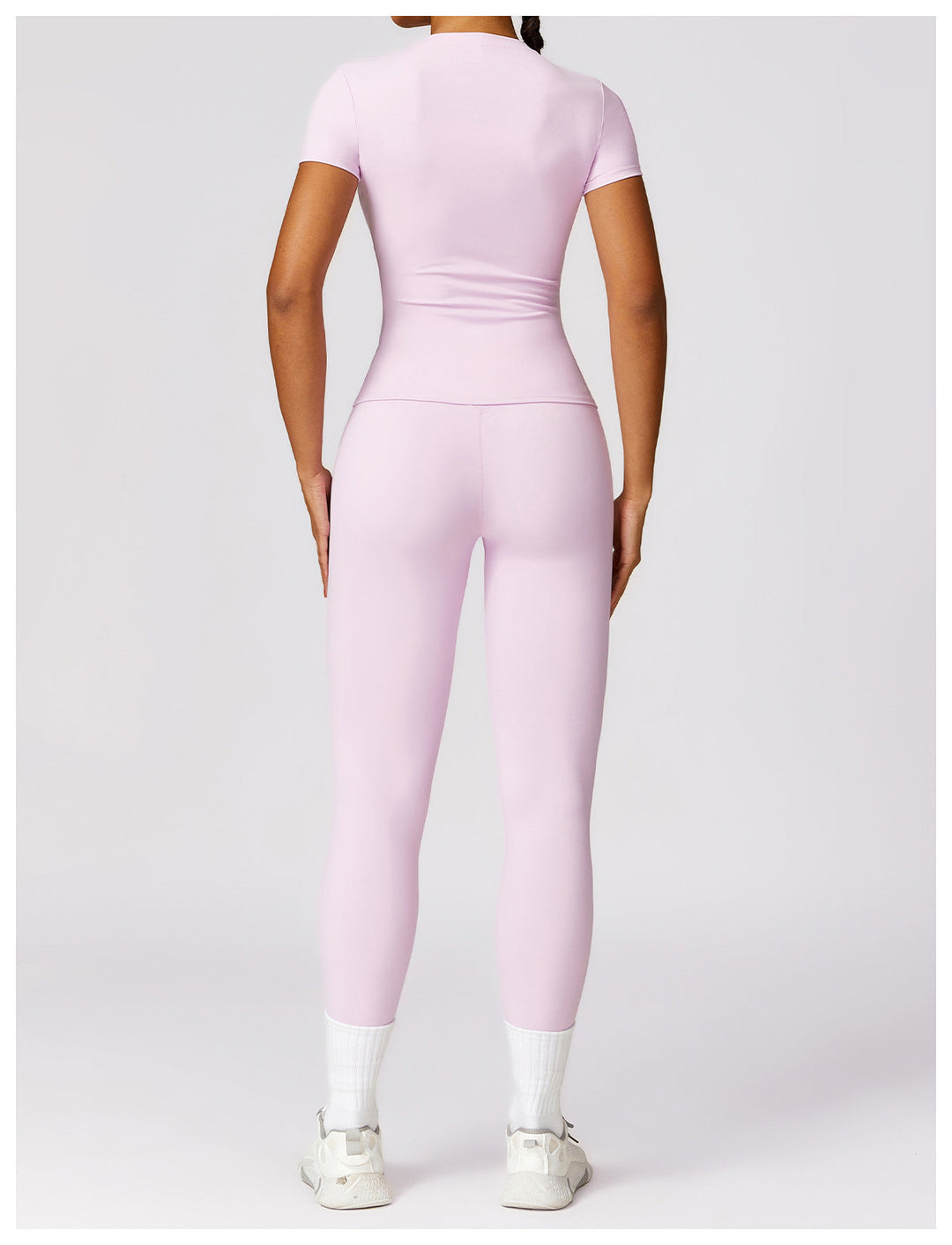 Back view of woman wearing the pale pink shaping gym set