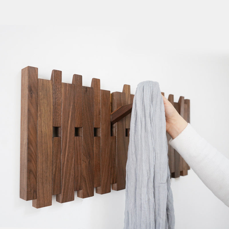 Side view of wooden coat hanger mounted on a clean white wall