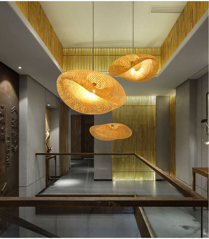 Handwoven rattan pendant light casting warm patterns, boho lighting