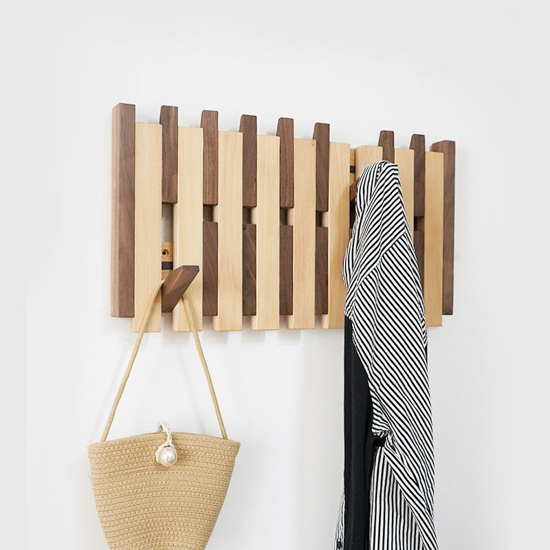 Minimalist wall mount coat hook displaying jackets and accessories