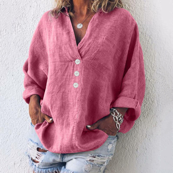 Woman wearing a pink oversized v-neck long sleeve casual blouse