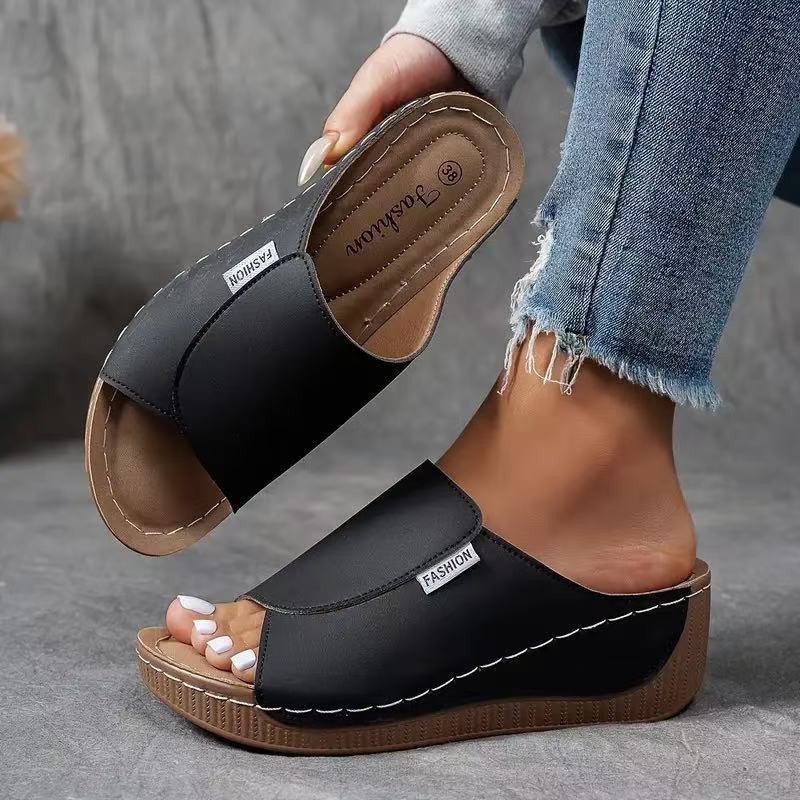 Black orthopedic arch support wedge sandals presented with a comfortable footbed