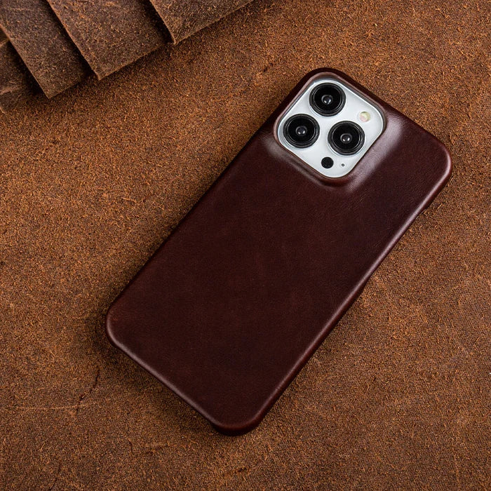 Minimalist leather iPhone case held in hand showing ergonomic grip