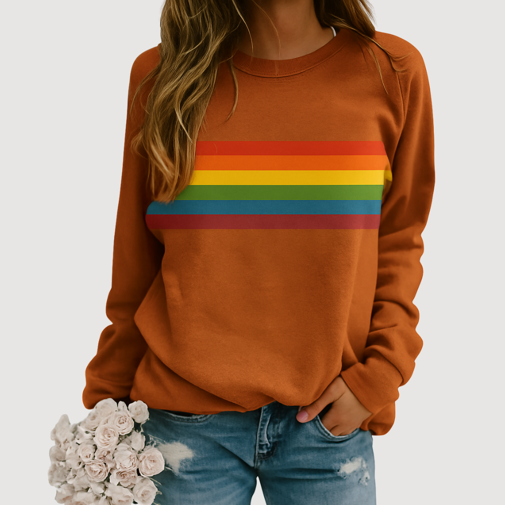Woman wearing khaki orange rainbow stripe crewneck sweatshirt holding flowers