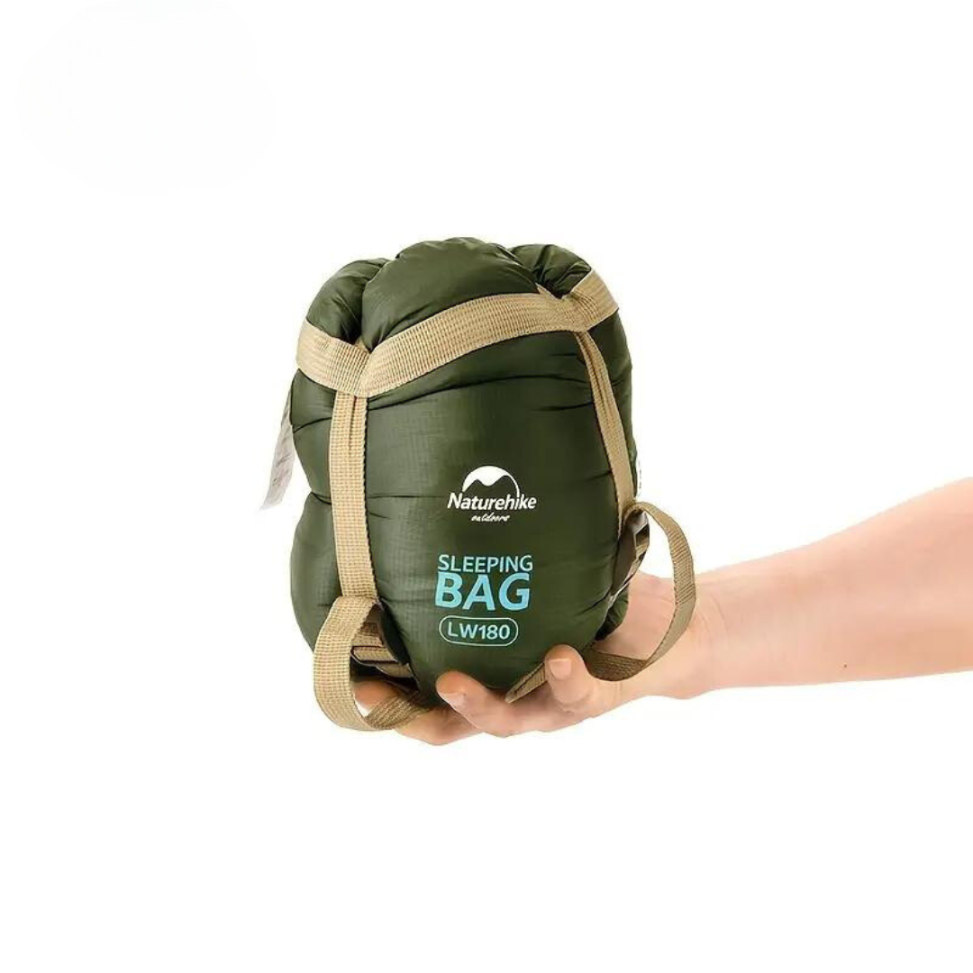 Compact rolled sleeping bag held in hand for easy travel