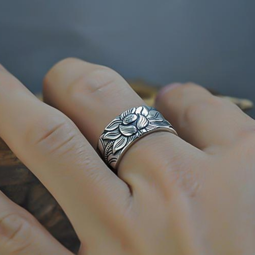 Person wearing the adjustable silver lotus flower ring on a finger