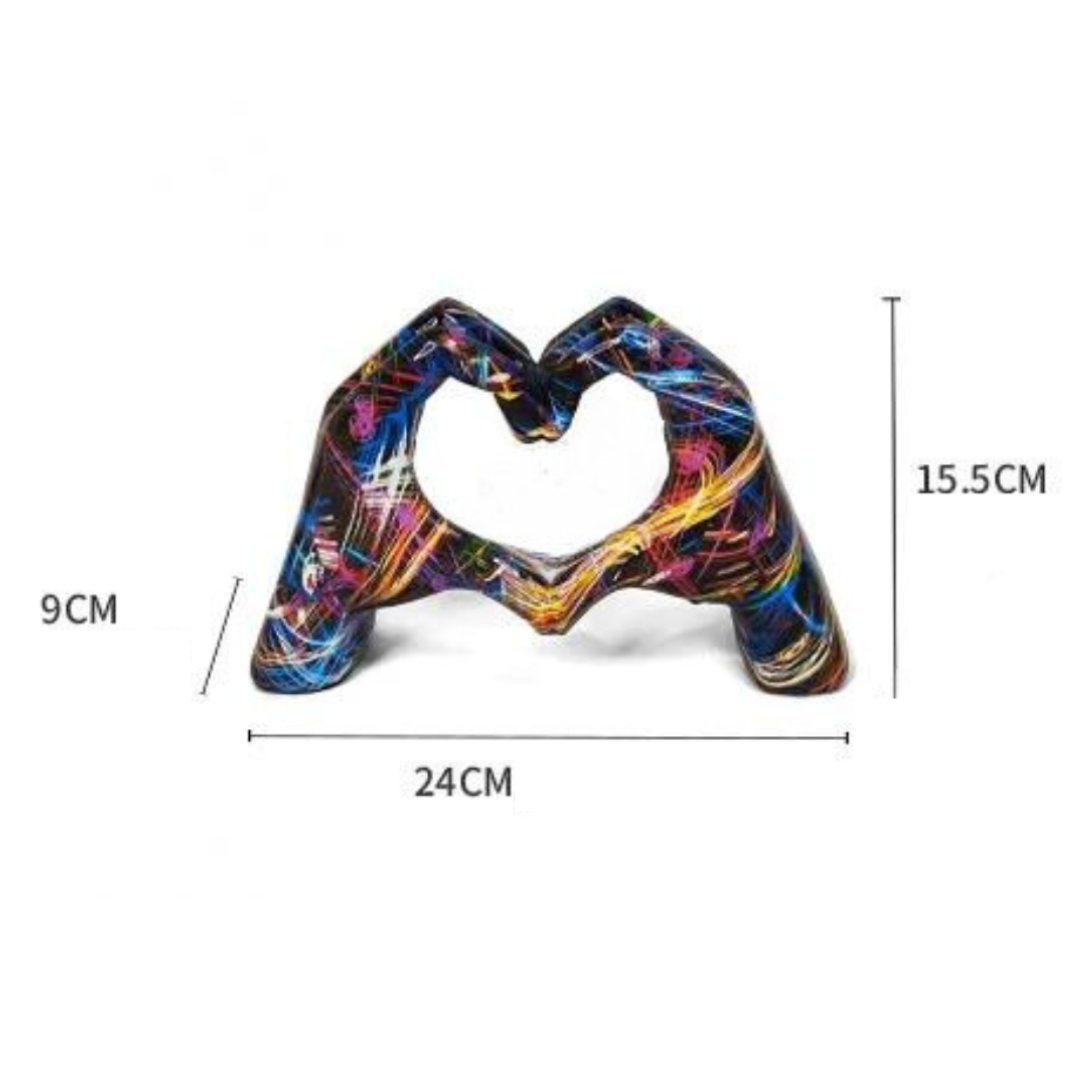 Close-up of resin colorful hand sculpture forming a heart shape for table decor