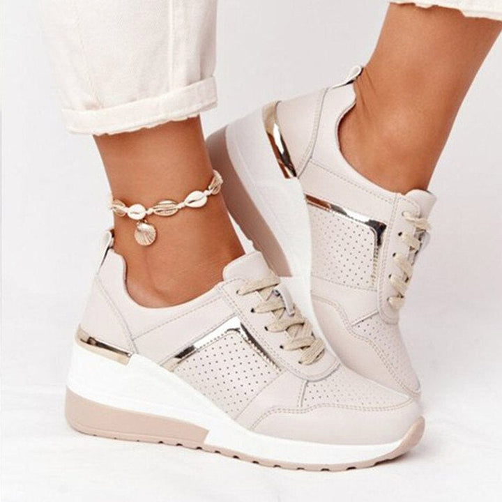 Close-up of women's beige orthopedic mesh comfort sneakers with metallic side details