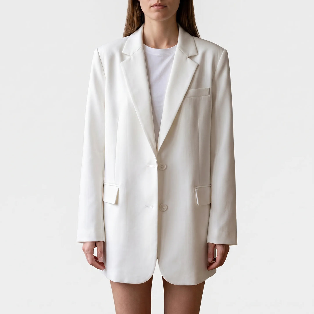 Front view of white oversized blazer against a neutral background