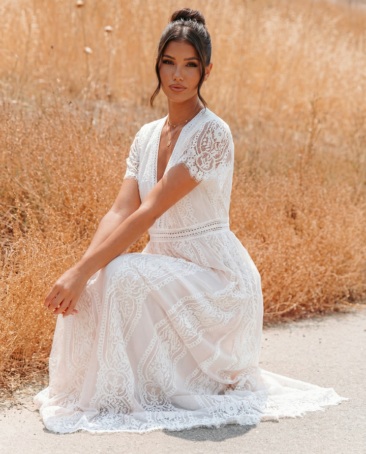 Close-up of intricate floral lace fabric texture on the maxi dress