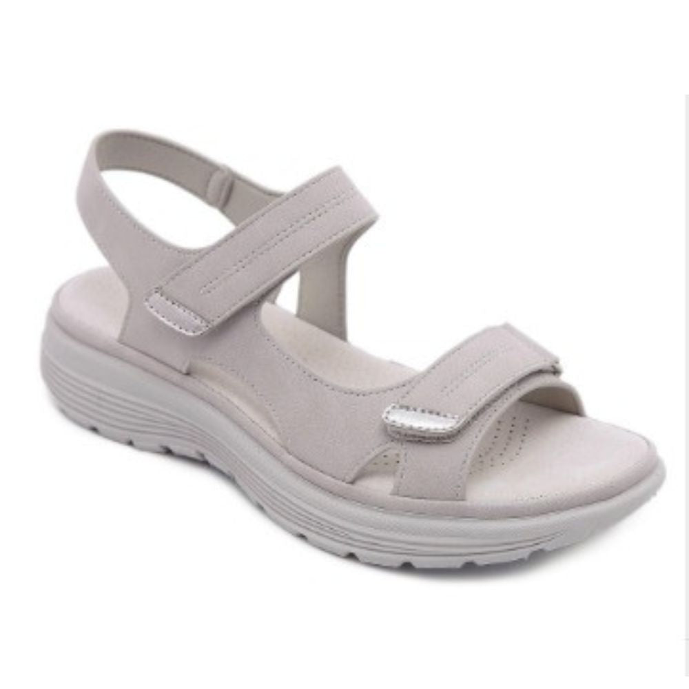 Studio product shot of beige sporty platform sandals with adjustable hook-and-loop closure straps.