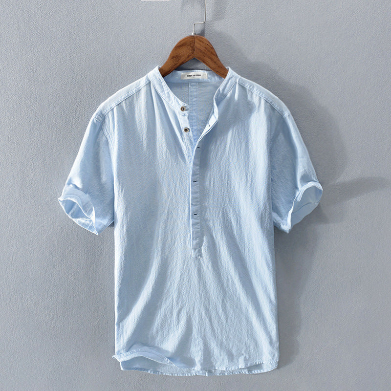 Light blue short sleeve men's shirt hanging on a hanger