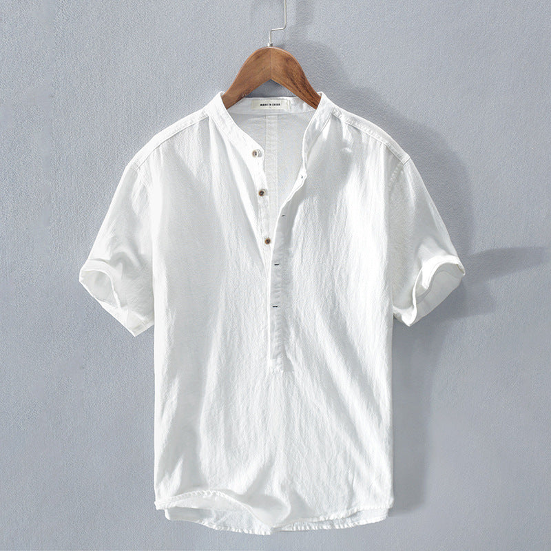 White short sleeve men's shirt hanging on a wooden hanger