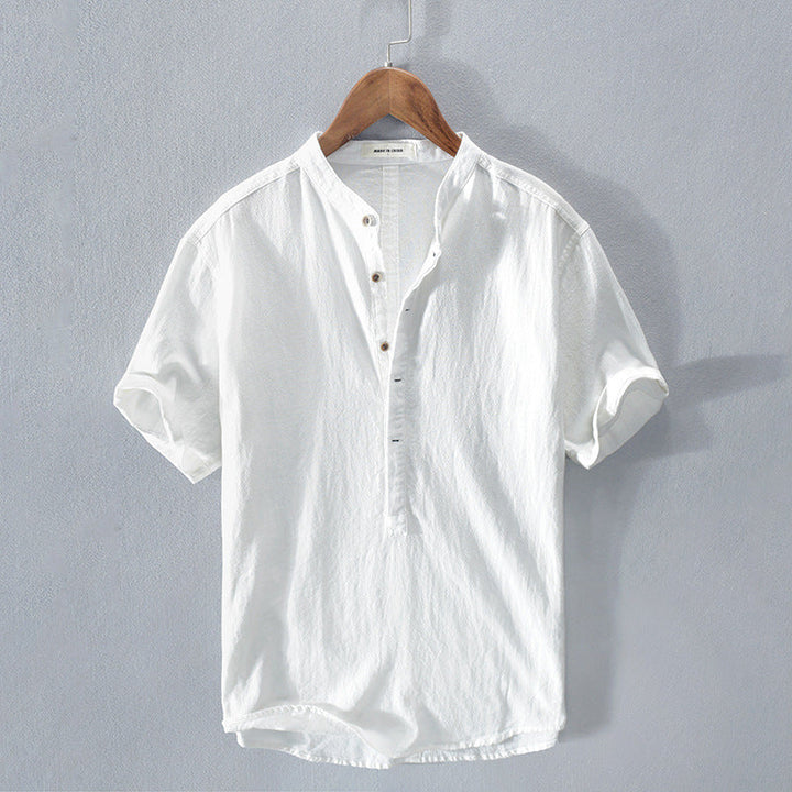 White short sleeve men's shirt hanging on a wooden hanger