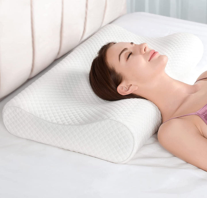 Close-up view of a woman resting on a contoured white cervical support pillow