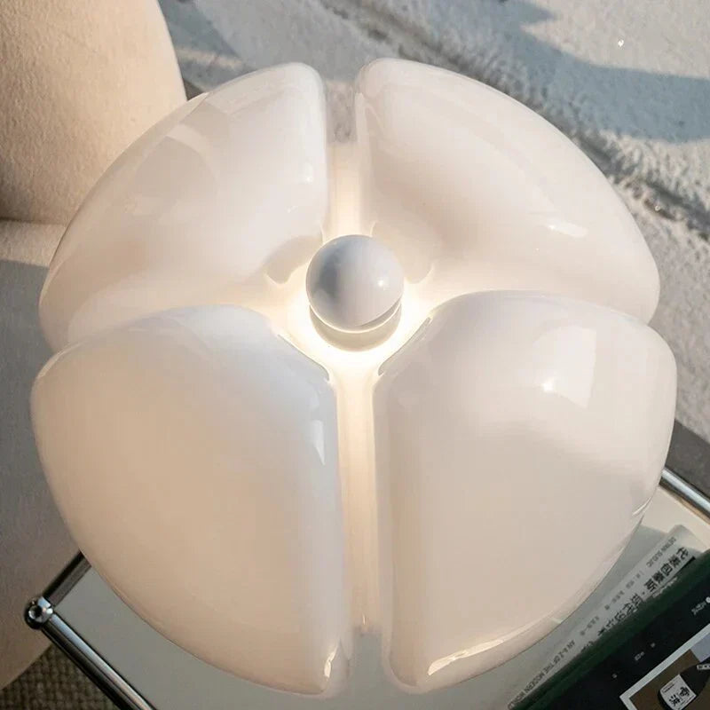 Top-down view of the flower table lamp showing its petal-shaped opal diffuser and central switch
