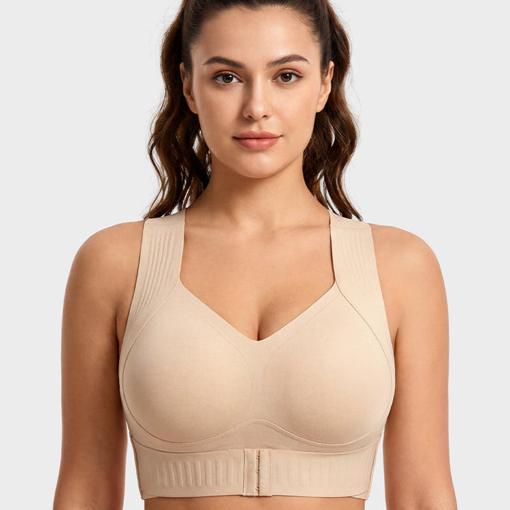 Woman wearing nude posture support wireless sports bra, front view