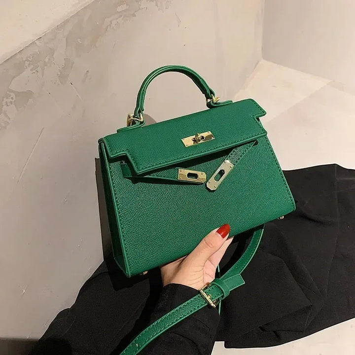 Green women's stylish shoulder bag showcased against a neutral wall