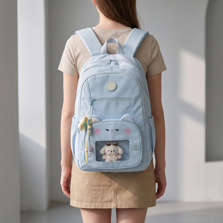 Back view of a person wearing an air blue preppy daypack with a clear front pocket