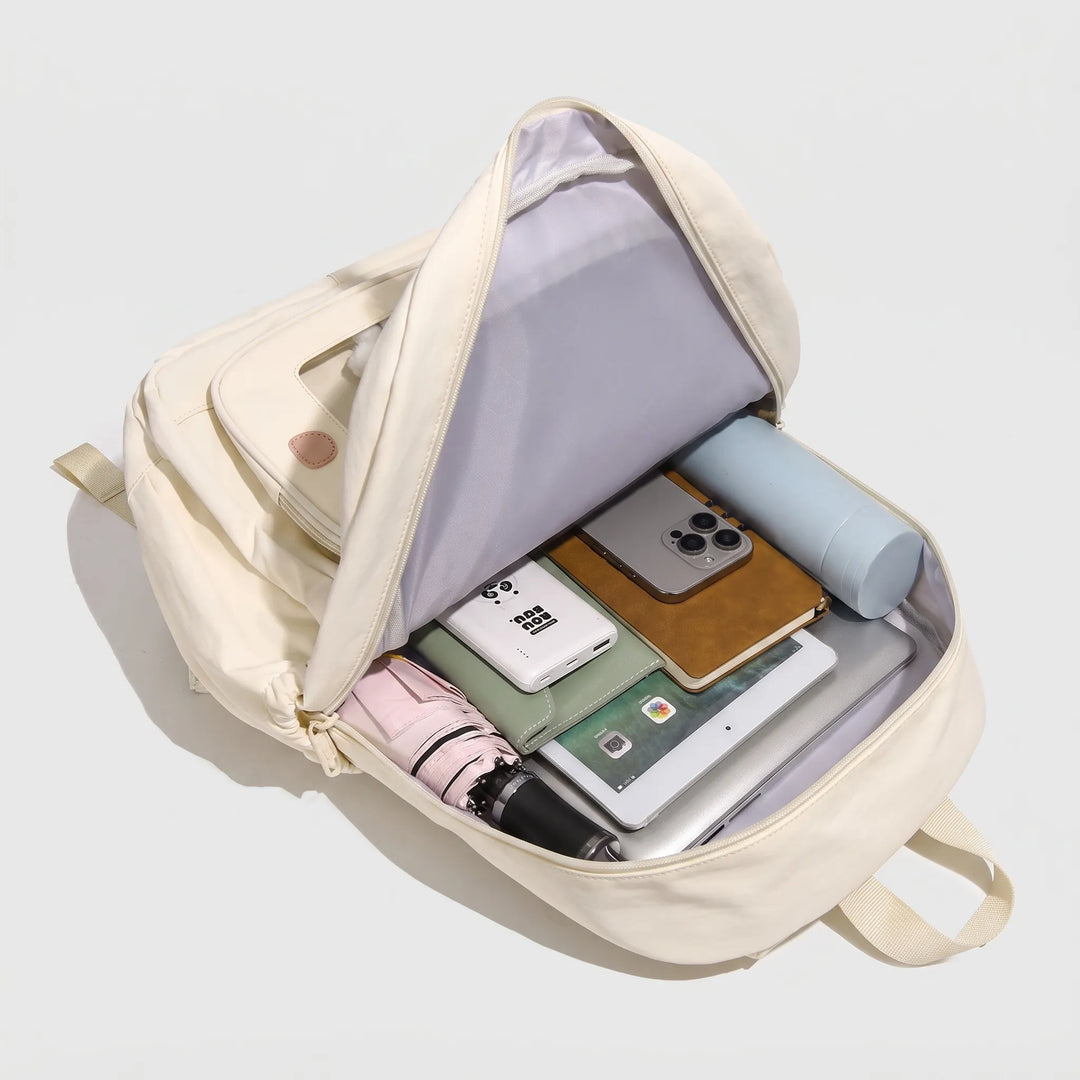Side angle view of the women's preppy style transparent pocket daypack showing its slim profile