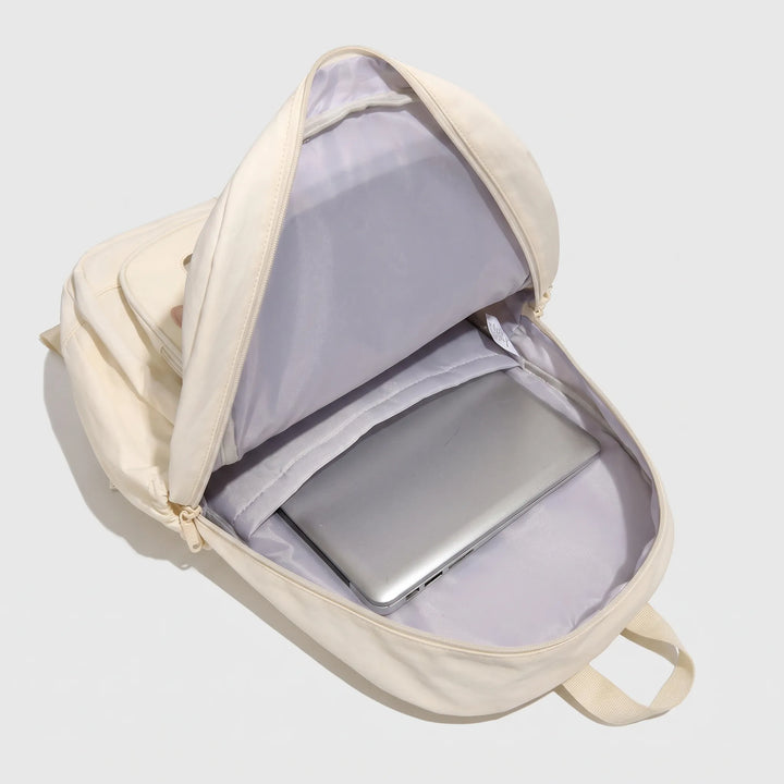 Close-up of the clear front pocket on the cute school bag displaying custom pin accessories