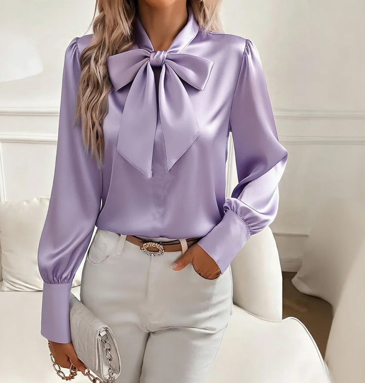 Stylish women's blouse showcasing a graceful bow tie and fitted cuffs