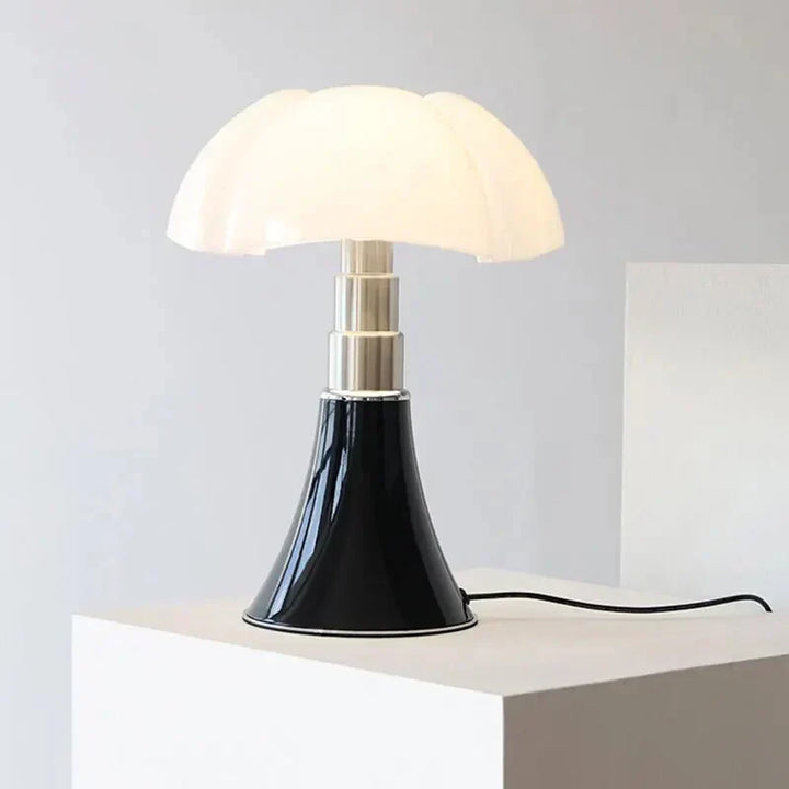 Designer flower table lamp glowing softly on a modern bedside table