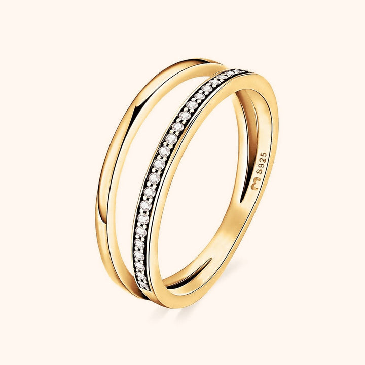 Gold double zirconia ring featuring a sparkling pave stone band and smooth metal band.