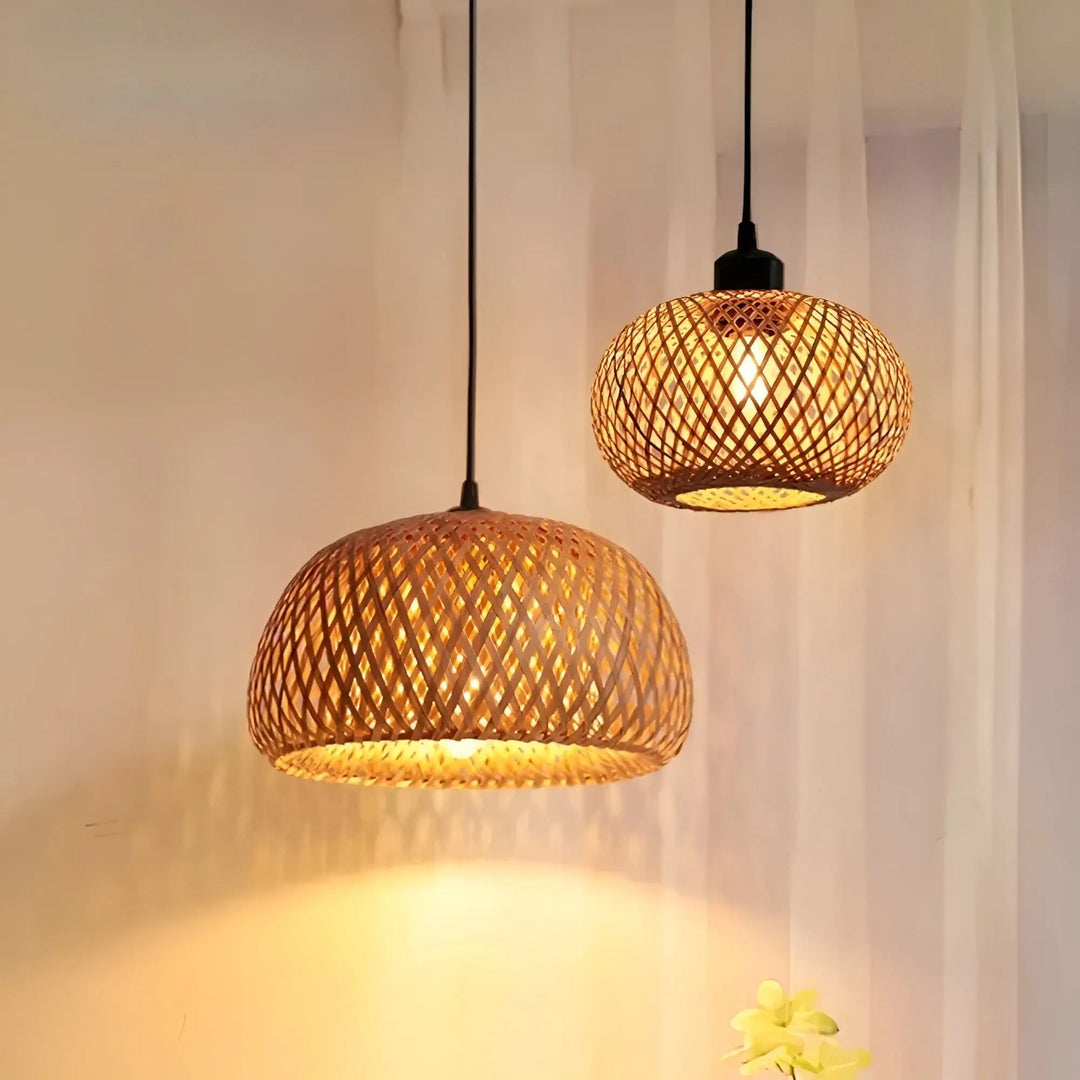 Two rattan pendant lamps hanging together displaying warm ambient illumination