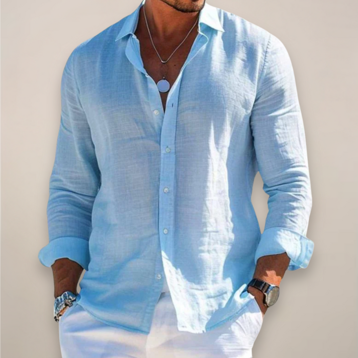 Man wearing a light blue long sleeve button-down shirt for warm weather