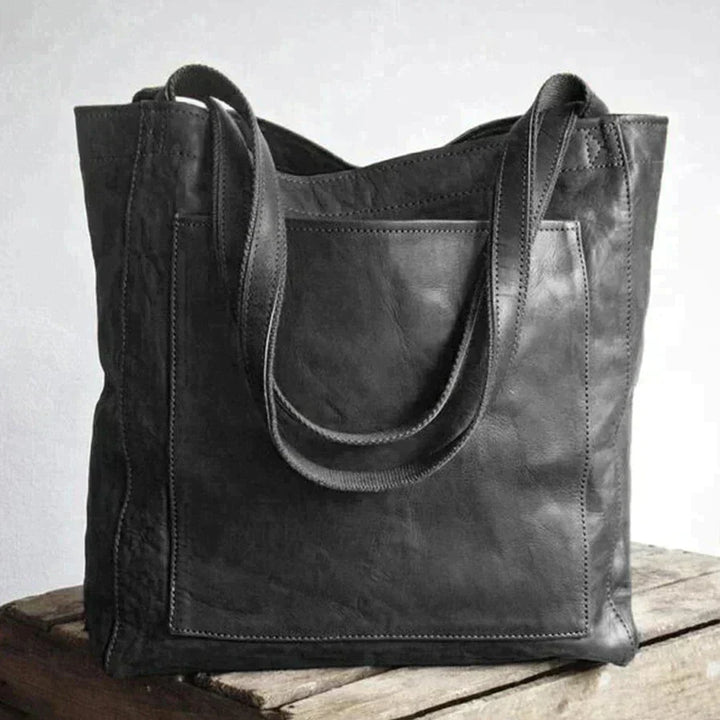 Close-up of premium metal hardware and clasp detail on fashion tote bag